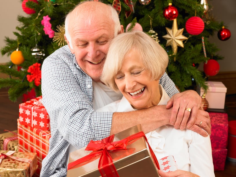 older-adults-smiling-and-giving-each-ther-gifts-for-Christmas